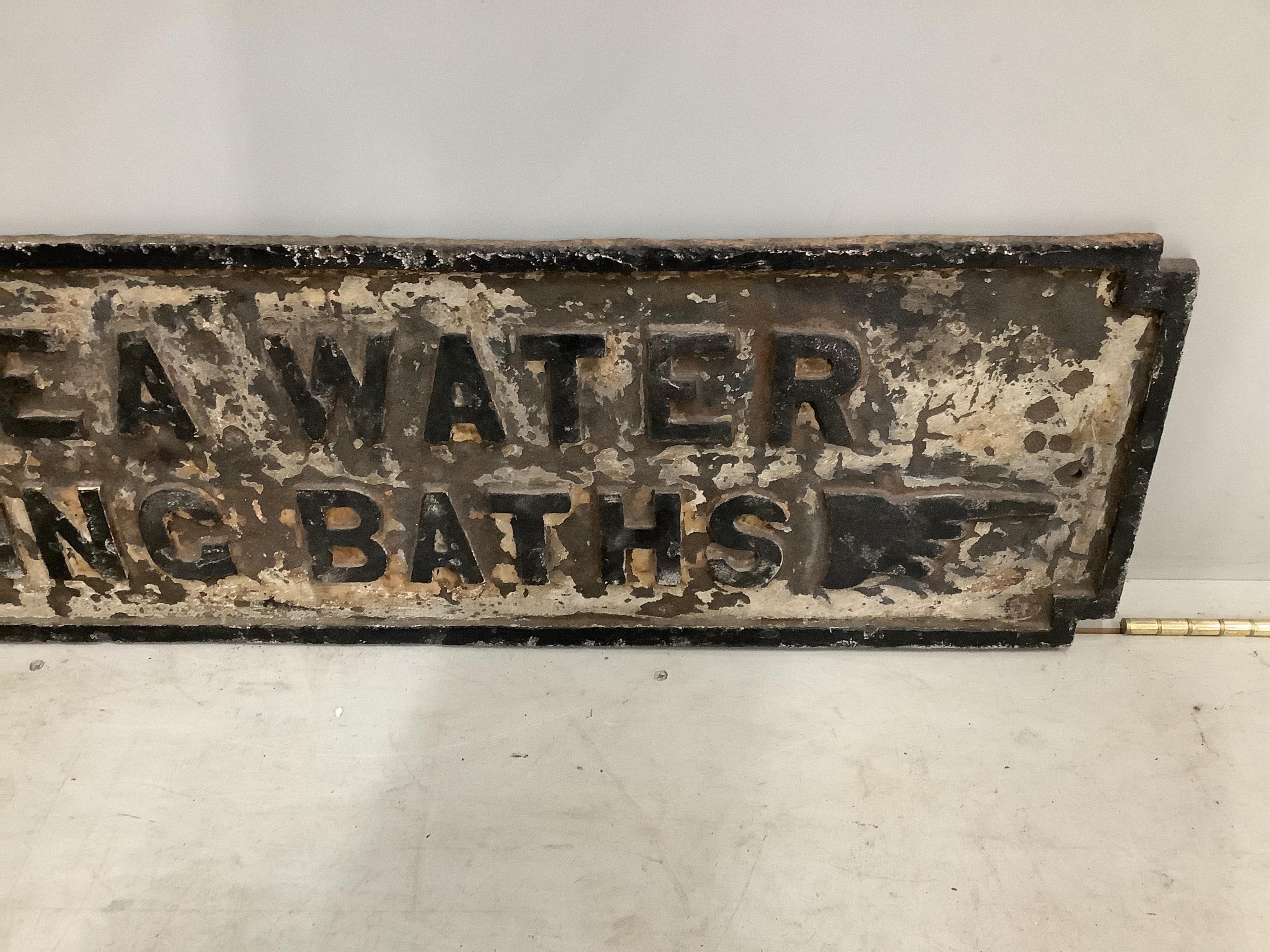 A vintage cast iron sign 'TO SEA WATER SWIMMING BATHS', originally from The Southport Lido, width 117cm, height 29cm. Condition - fair